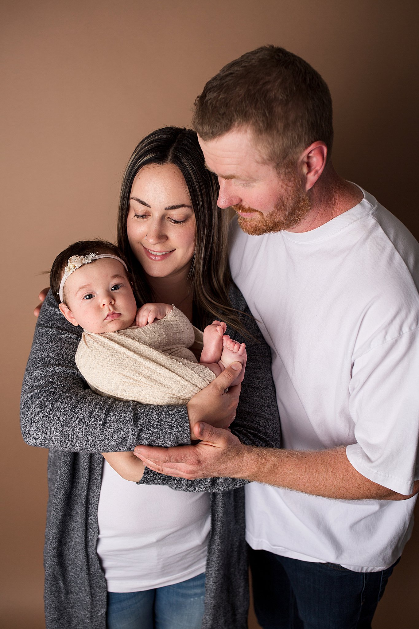 baby girl newborn photography parent posing with mom and dad