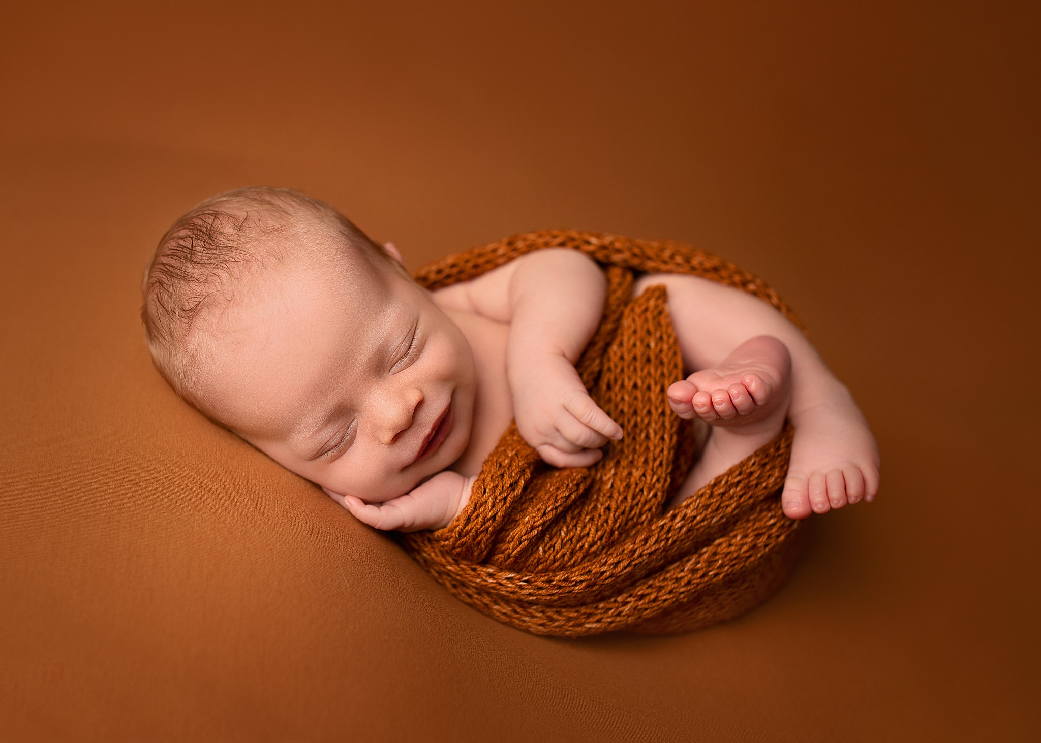 studio newborn photography baby boy beanbag pose pumpkin spice colour