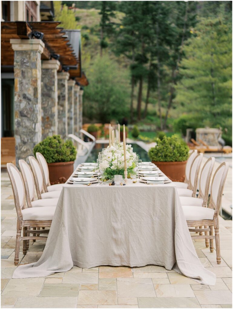 A wedding table set up with candles and florals at Chateau Okanagan