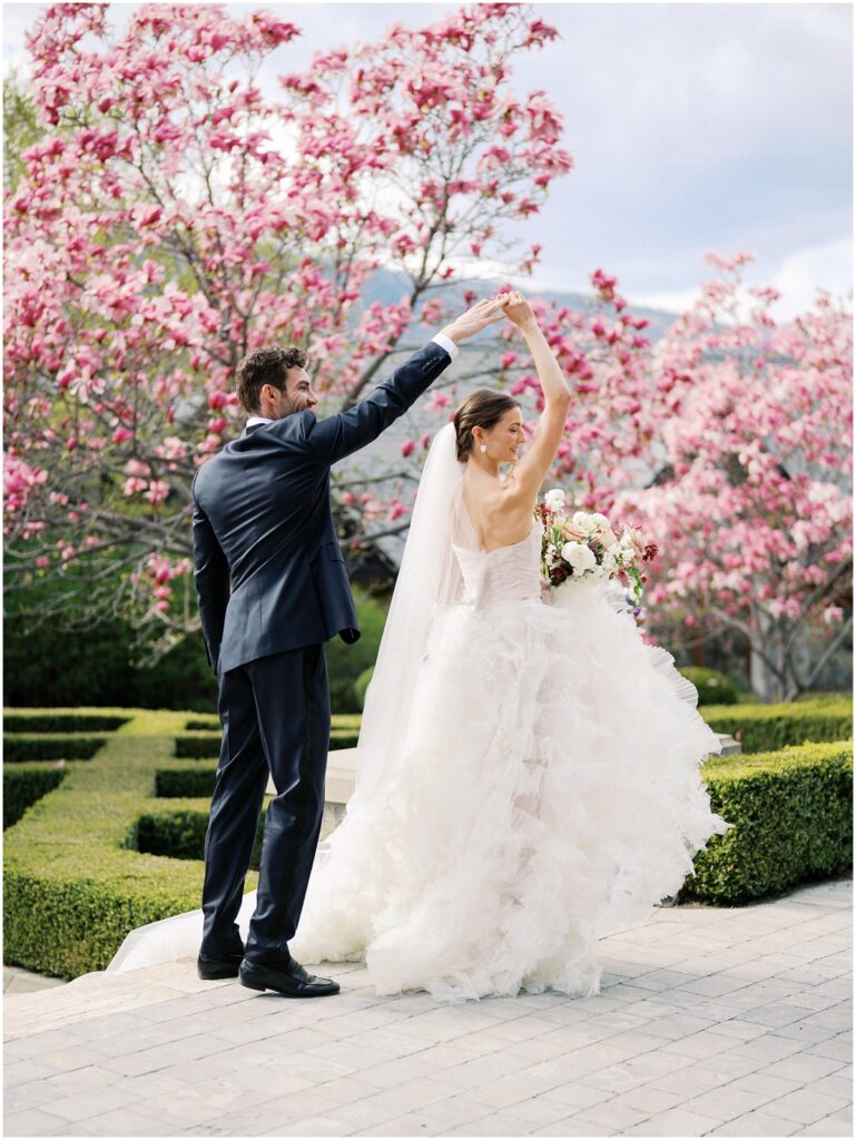 A bride and groom pose for photos for a European inspired wedding editorial at Chateau Okanagan.