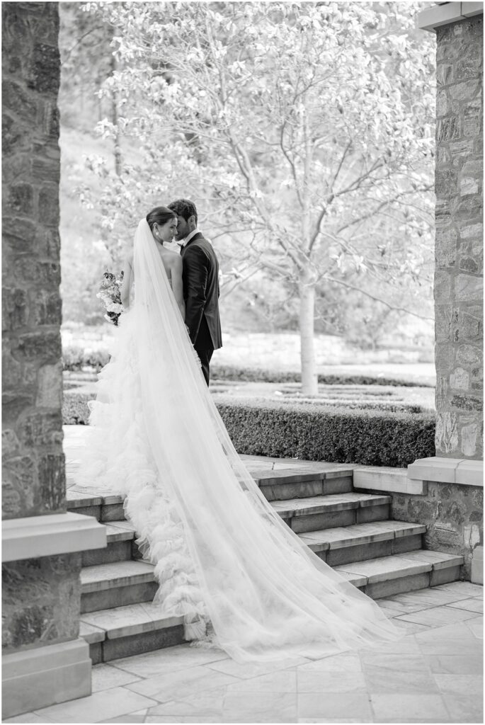 A bride and groom pose for photos for a European inspired wedding editorial at Chateau Okanagan.